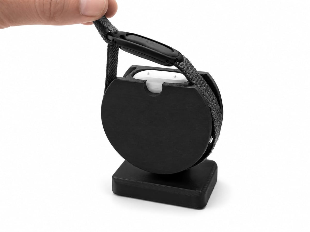 CleanHold Air Curve in Schwarz – eine Hand legt die Uhr am Band auf den Ständer
